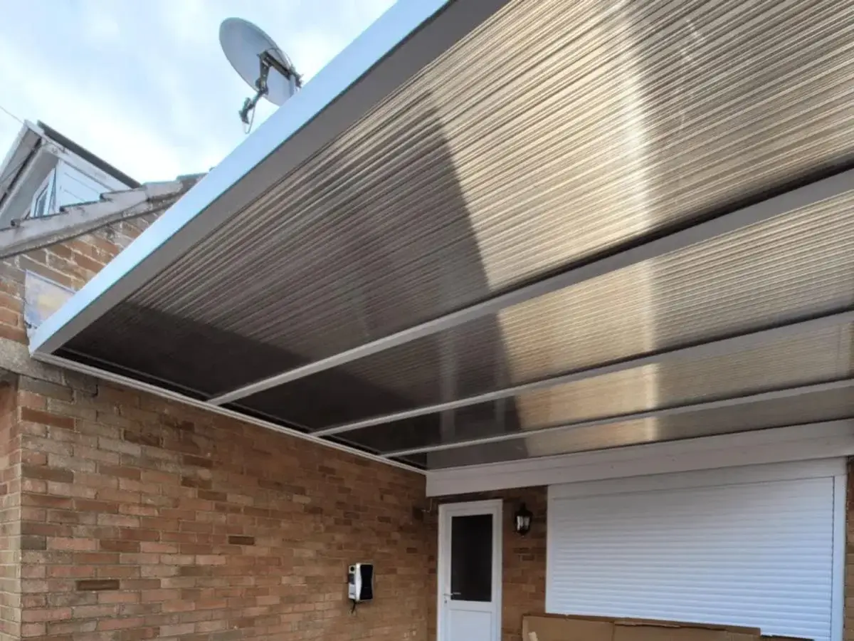 High-performance white uPVC shiplap cladding system installed with custom window trims on a domestic home by Norfolk Exterior Solutions